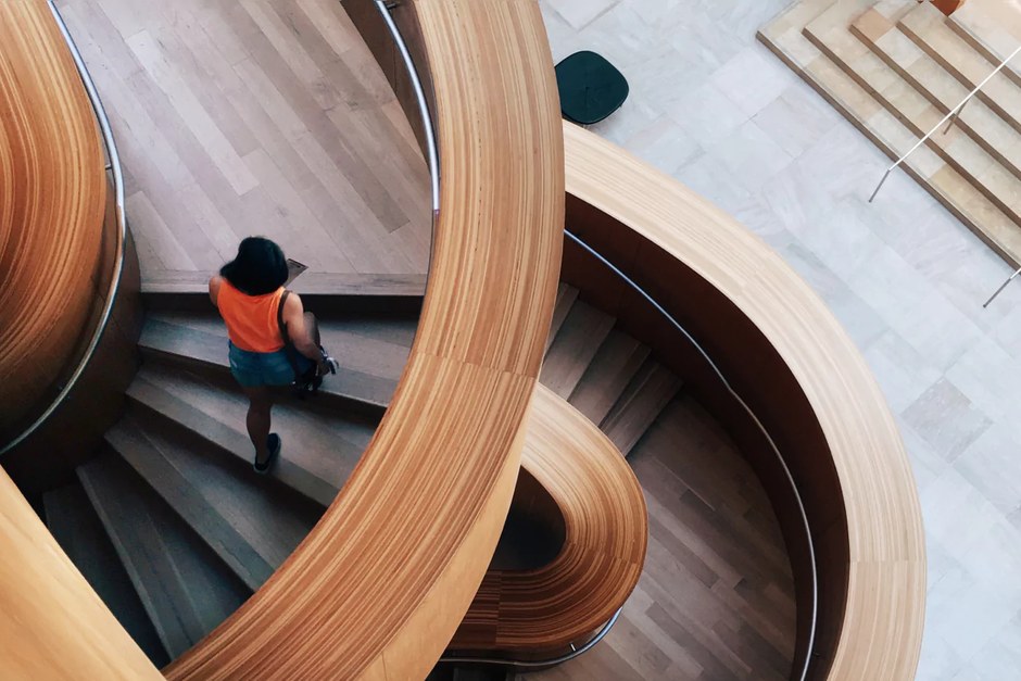 A contemporary gallery interior with warm sculptural curves and natural light.