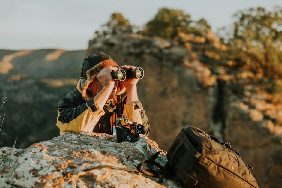 A photographer with a camera during an outdoor walk.